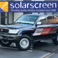 SUV with 'Cliffords Motors' branding in front of a building with 'solarscreen' logo.
